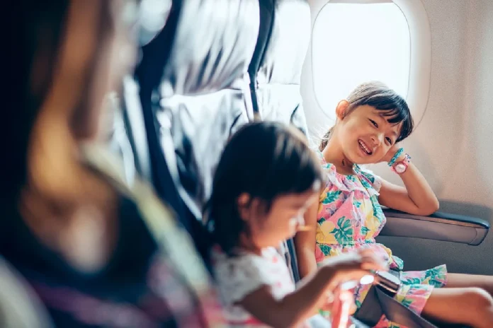 Niños sentados junto a familia en avión